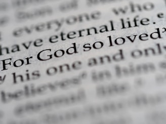 a close up of the word for god so loved written in a dictionary