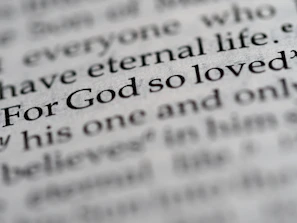 a close up of the word for god so loved written in a dictionary