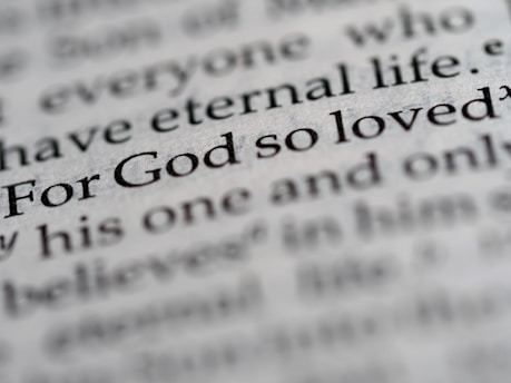 a close up of the word for god so loved written in a dictionary