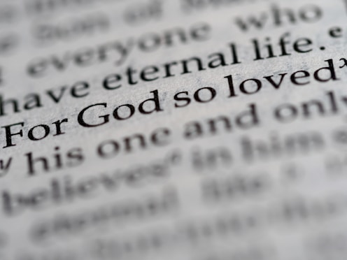 a close up of the word for god so loved written in a dictionary