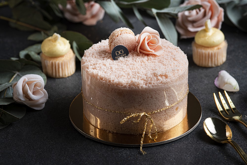 a frosted cake sitting on top of a gold plate