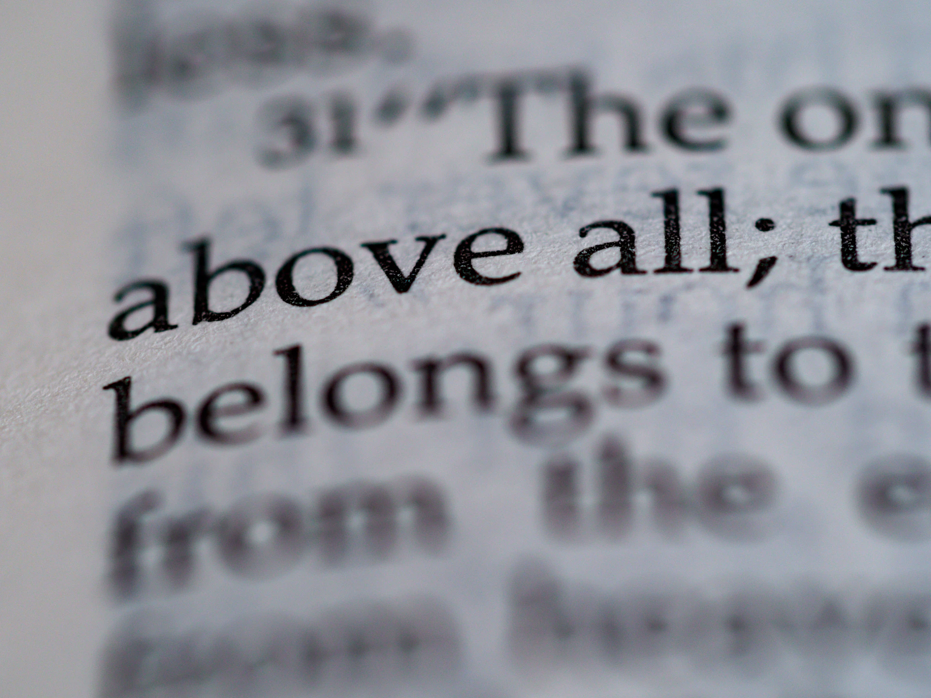 a close up of the word above all the belongs to the bible