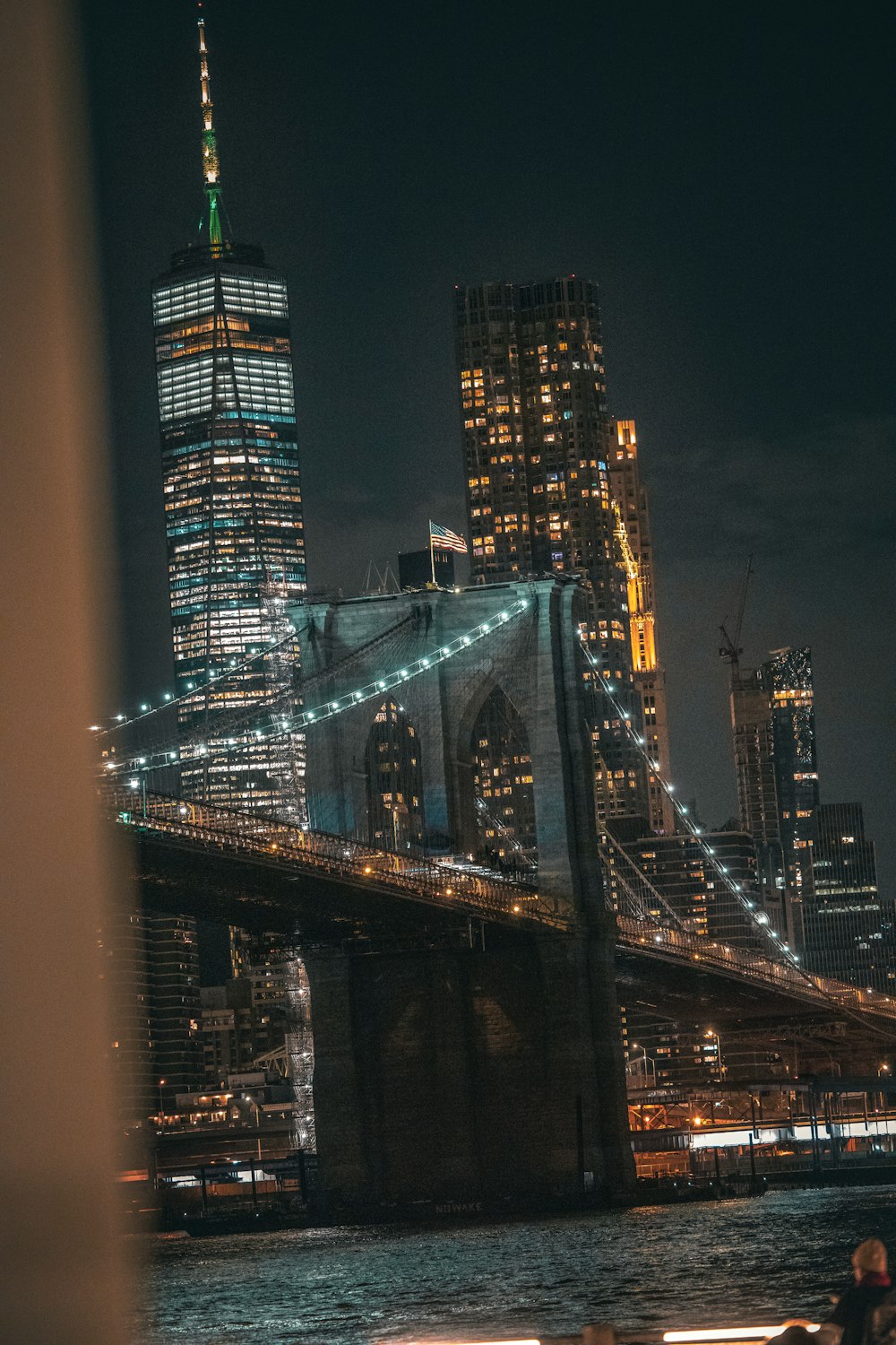 a view of the brooklyn bridge at night