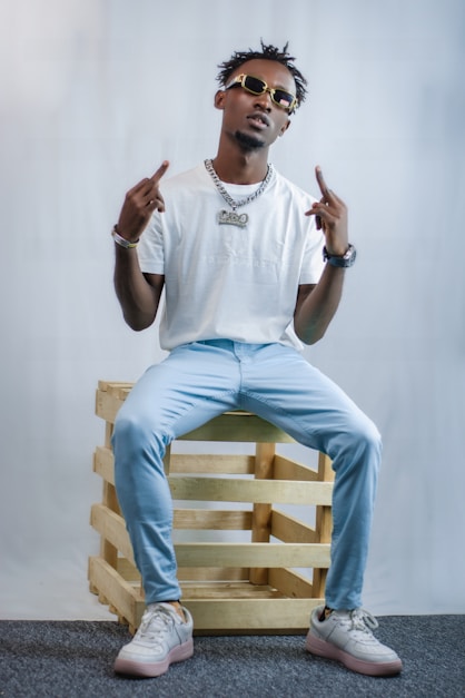a man sitting on top of a wooden crate