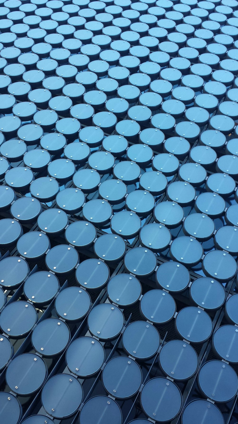 a close up view of a building made of blue barrels