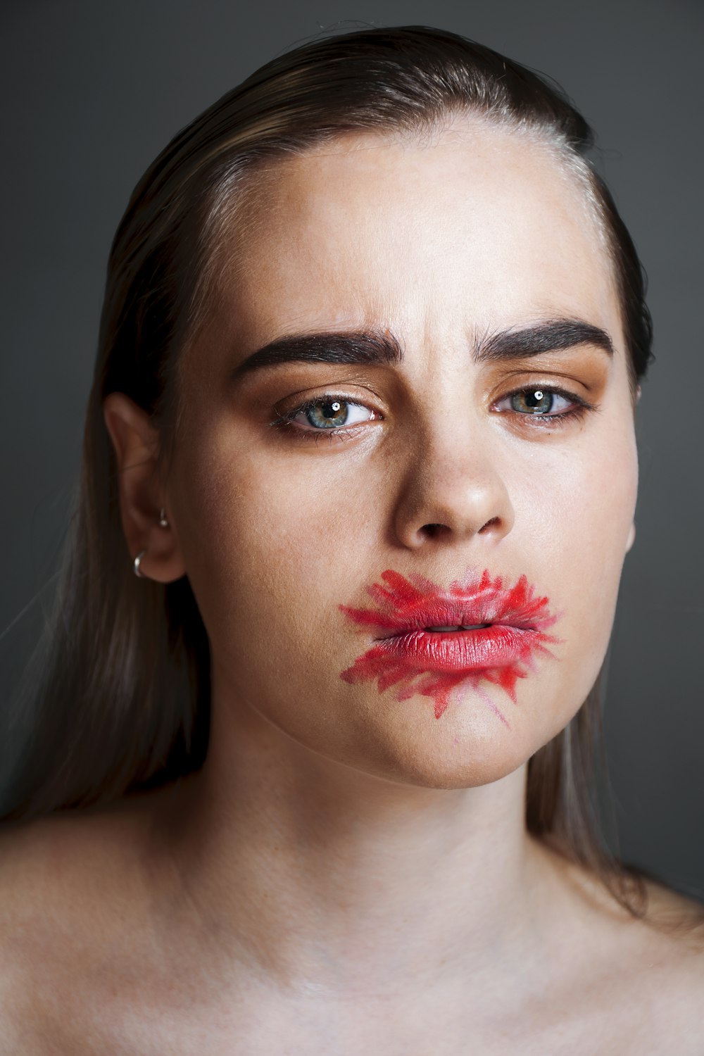 a woman with red lipstick on her face