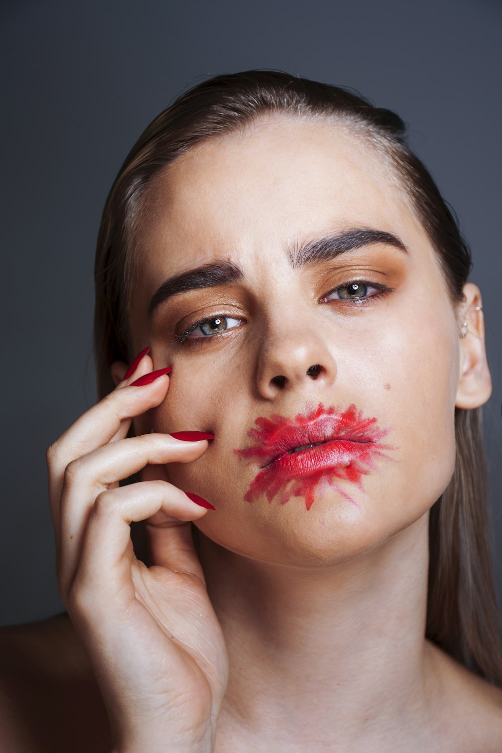 a woman with red lipstick on her face