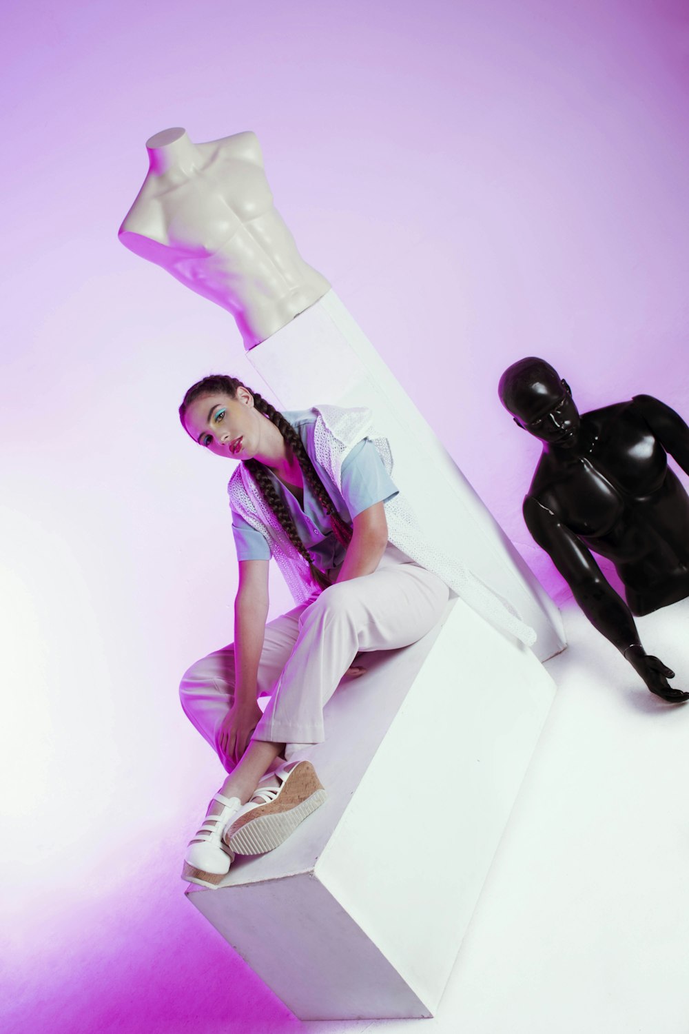 a woman sitting on top of a white box