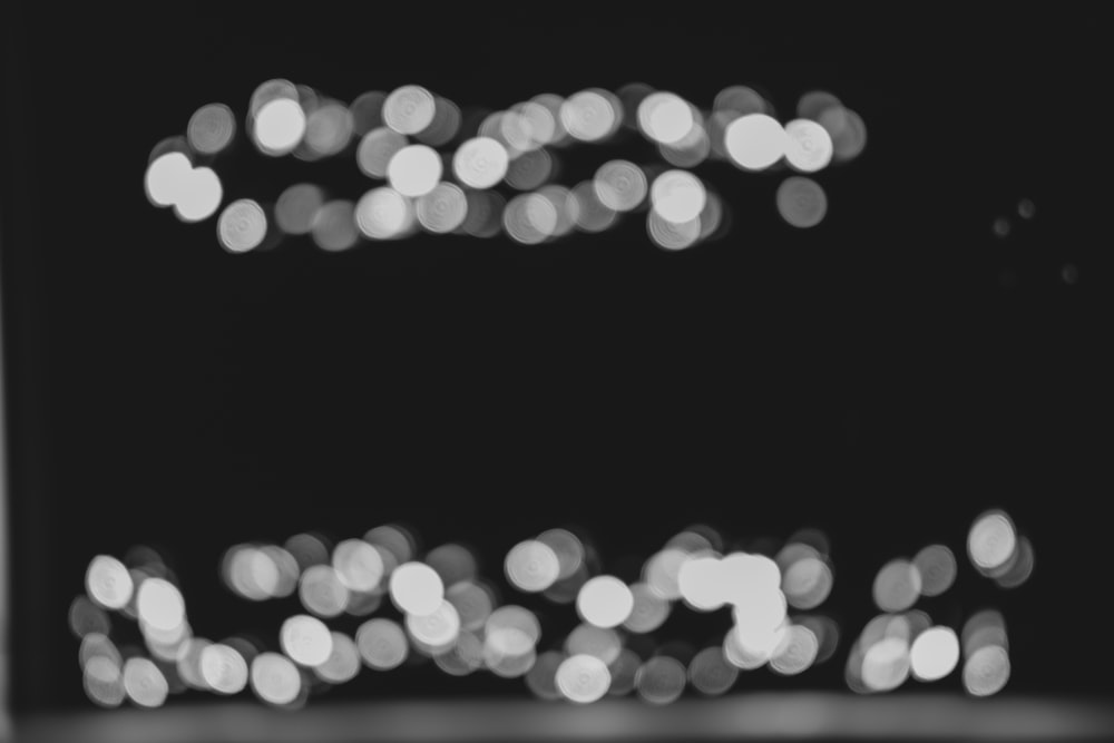 a black and white photo of lights in the dark