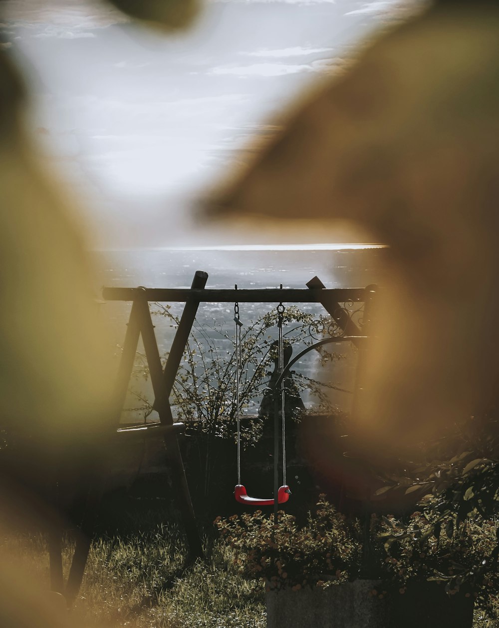 a swing set with a view of a body of water