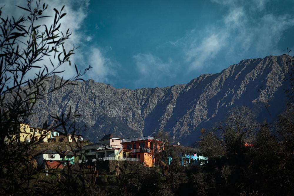 a view of a mountain range with houses in the foreground