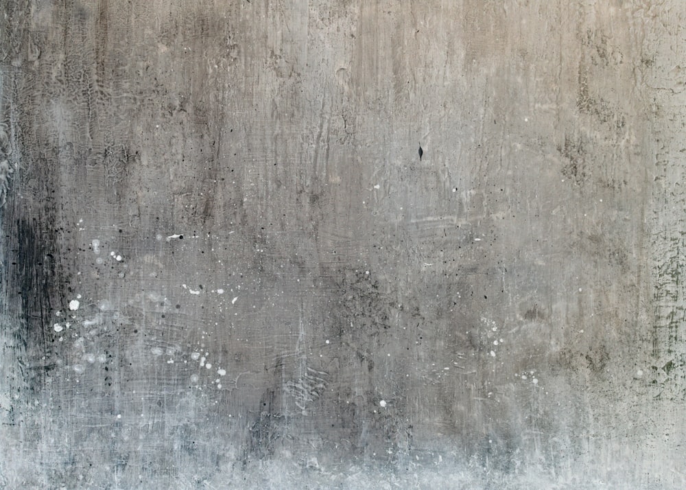 a grungy concrete wall with white paint