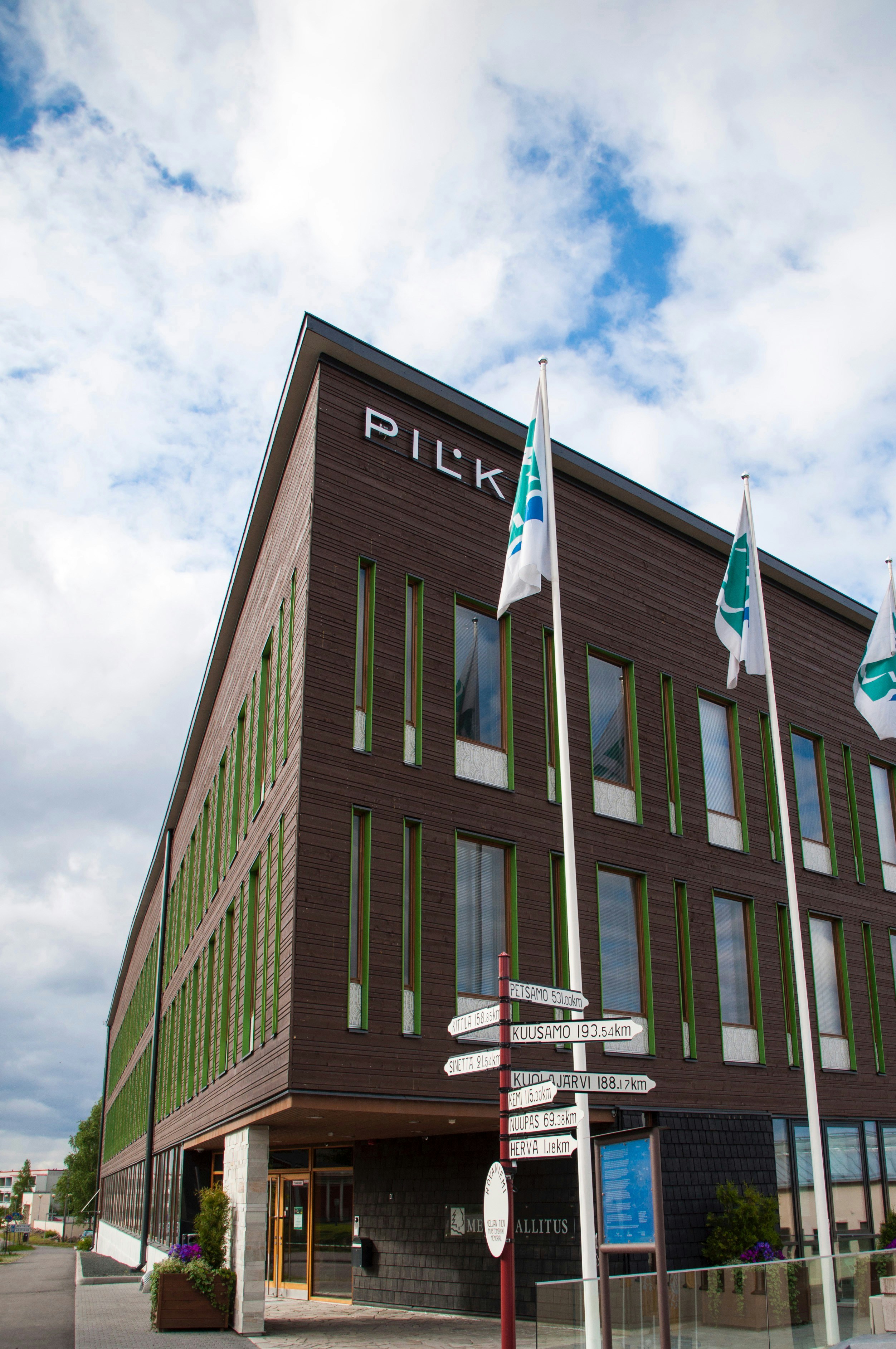 a large brown building with a sign in front of it