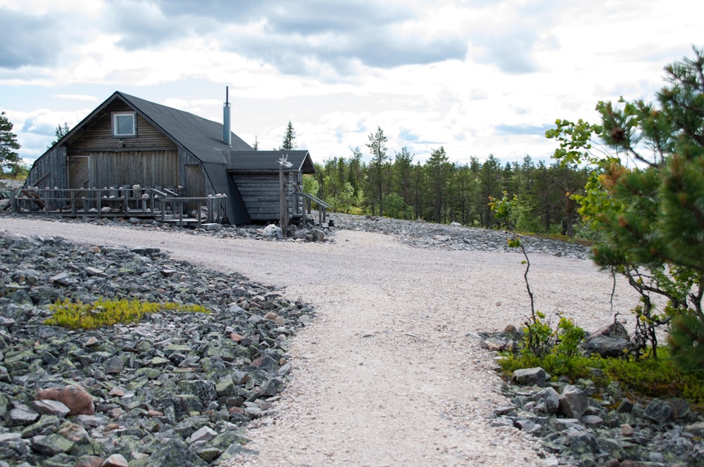 a wooden cabin sitting on top of a rocky hillside