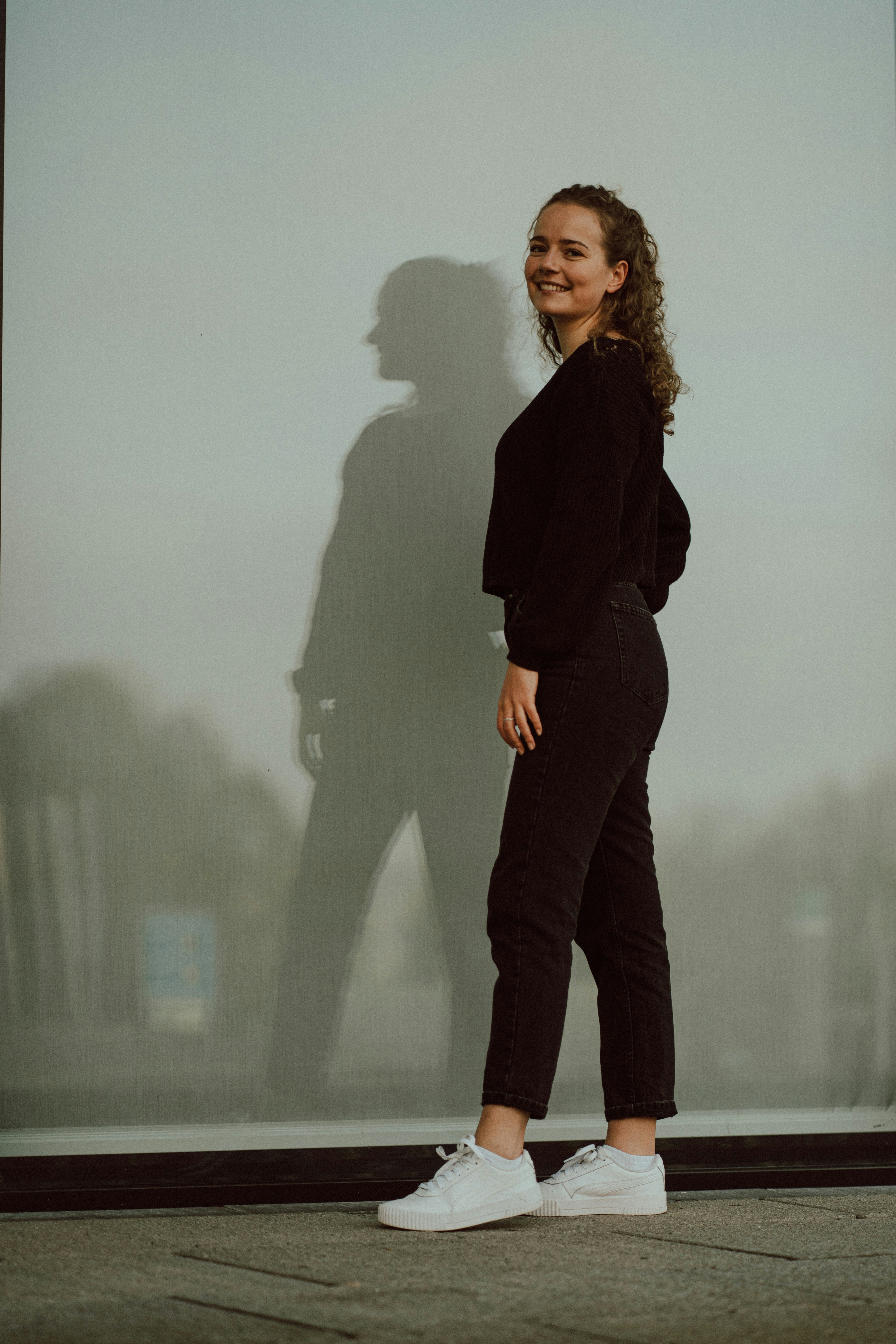 A woman standing in front of a large picture photo – Free Girl Image on ...