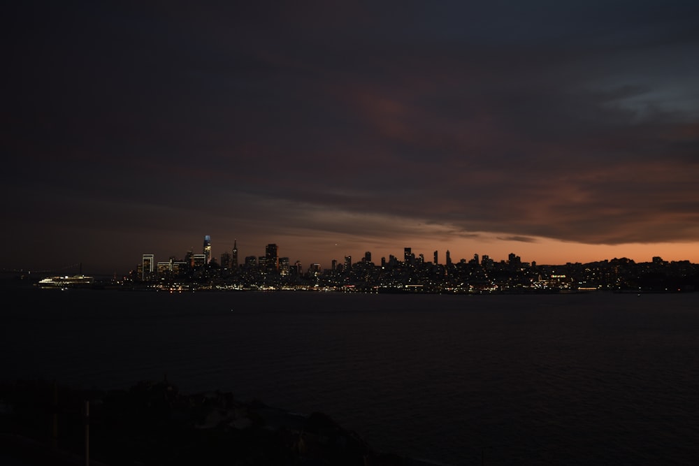 a view of a city at night from the water