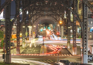 a view of a city street at night from a bridge