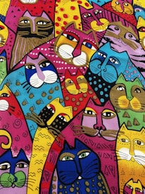 A colorful and whimsical illustration featuring a variety of cats with unique patterns and expressions. The cats are depicted in vibrant hues, including blue, red, yellow, and purple, with diverse designs like stripes, polka dots, and geometric shapes.