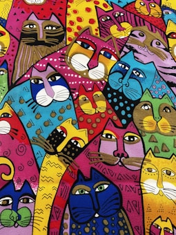 A colorful and whimsical illustration featuring a variety of cats with unique patterns and expressions. The cats are depicted in vibrant hues, including blue, red, yellow, and purple, with diverse designs like stripes, polka dots, and geometric shapes.