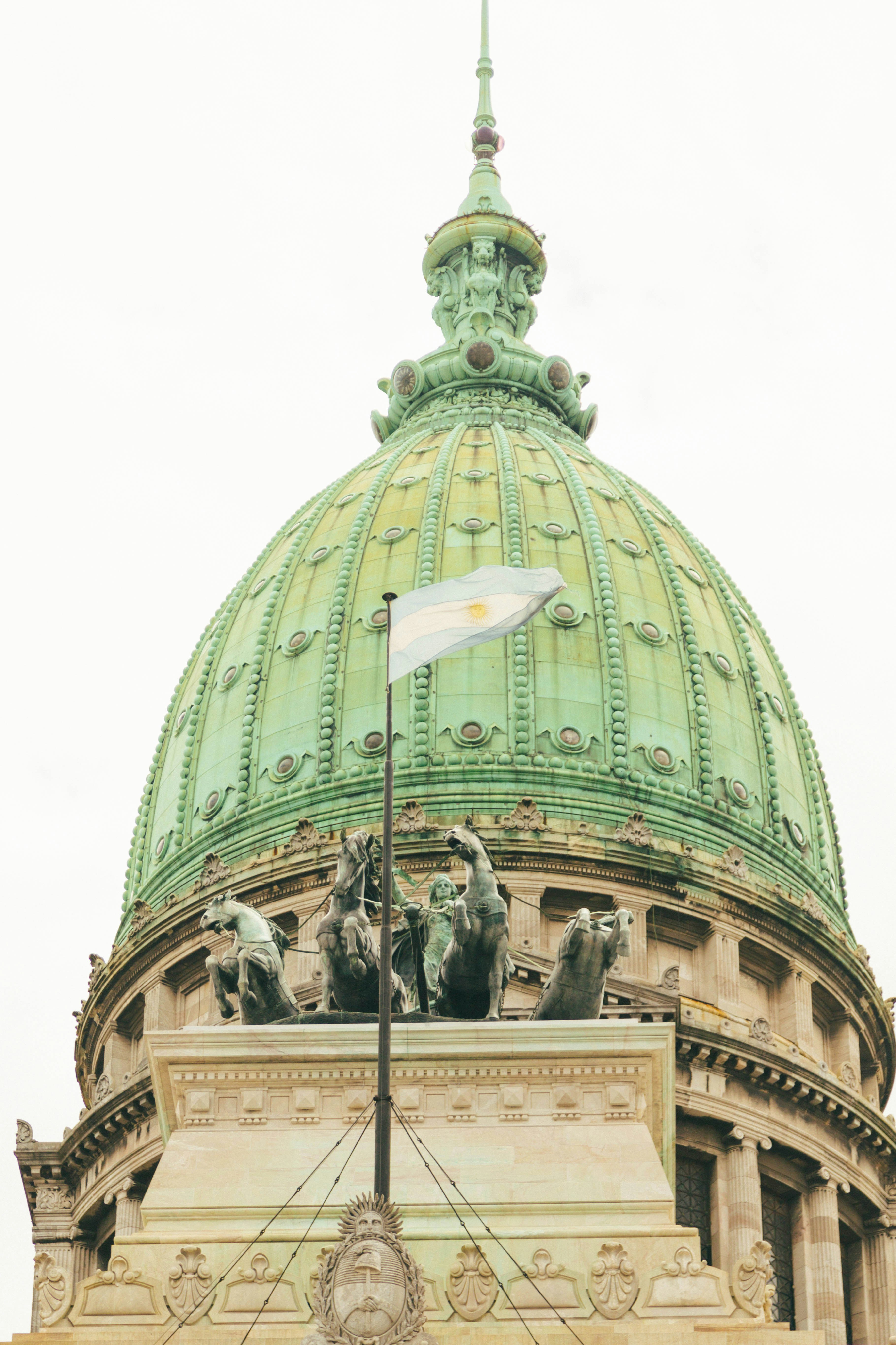 a large green dome with a flag on top of it