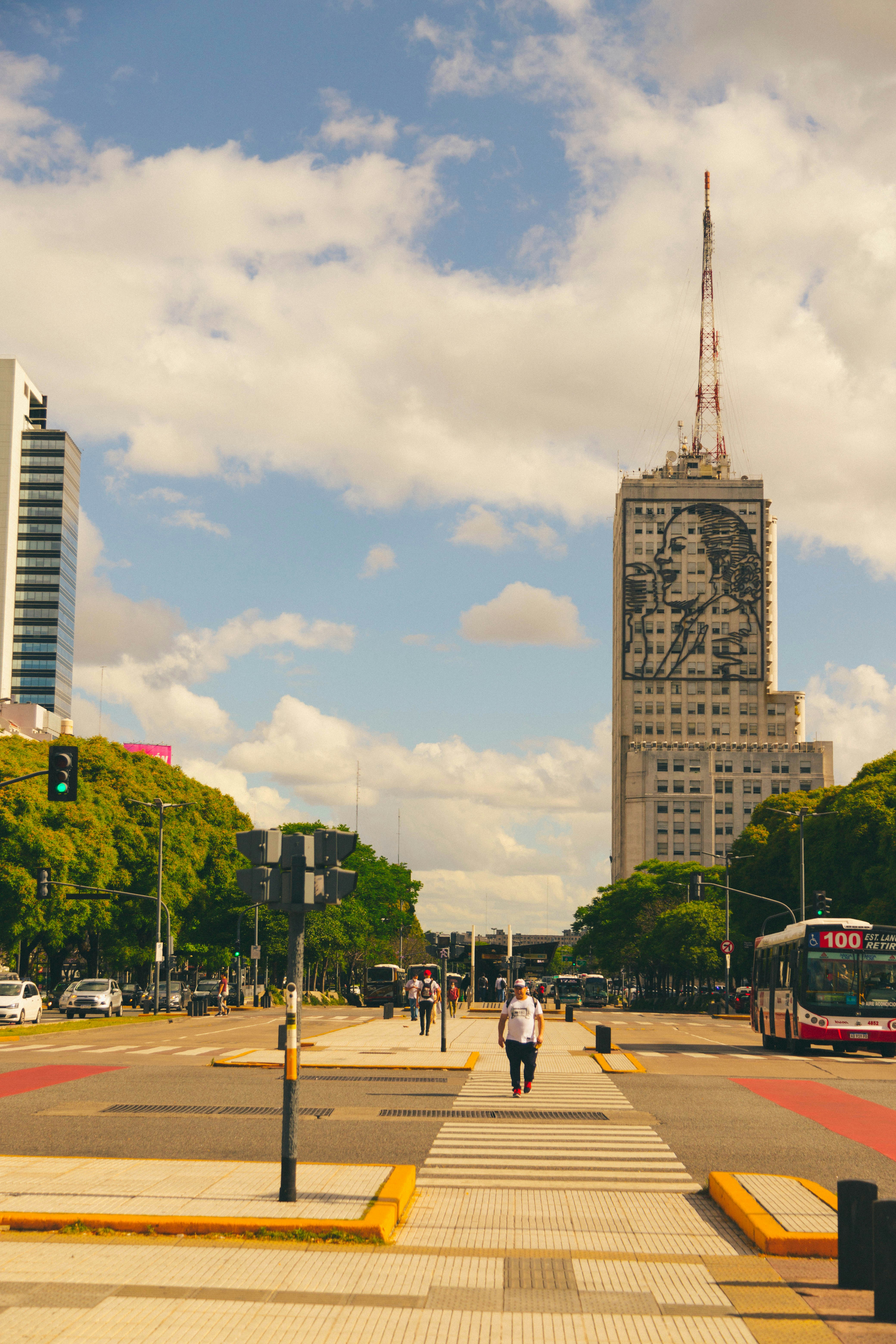 a city street with a tall building in the background