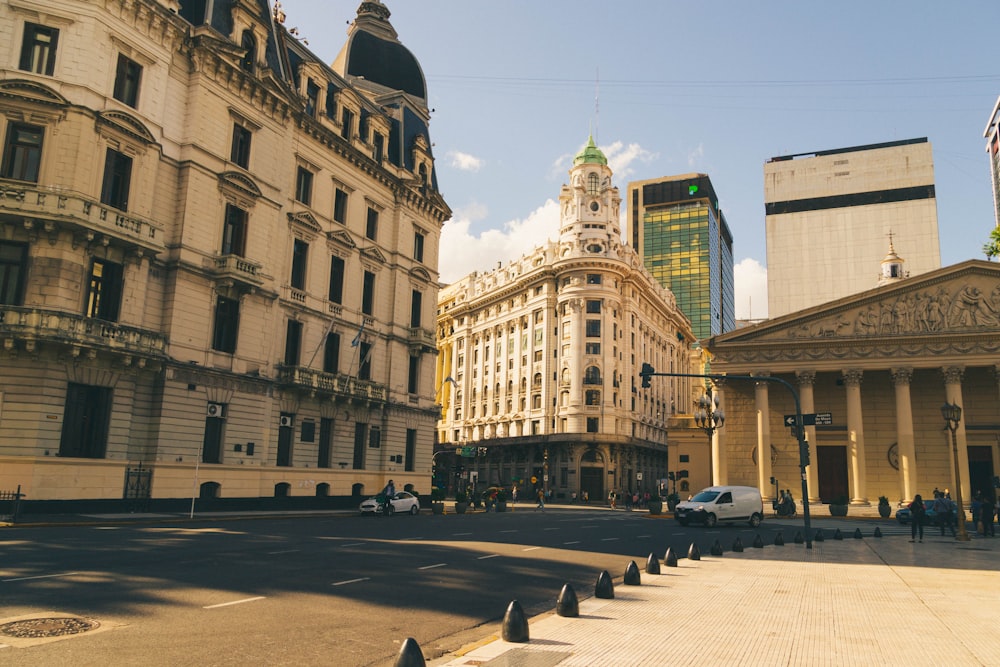 a city street with tall buildings in the background