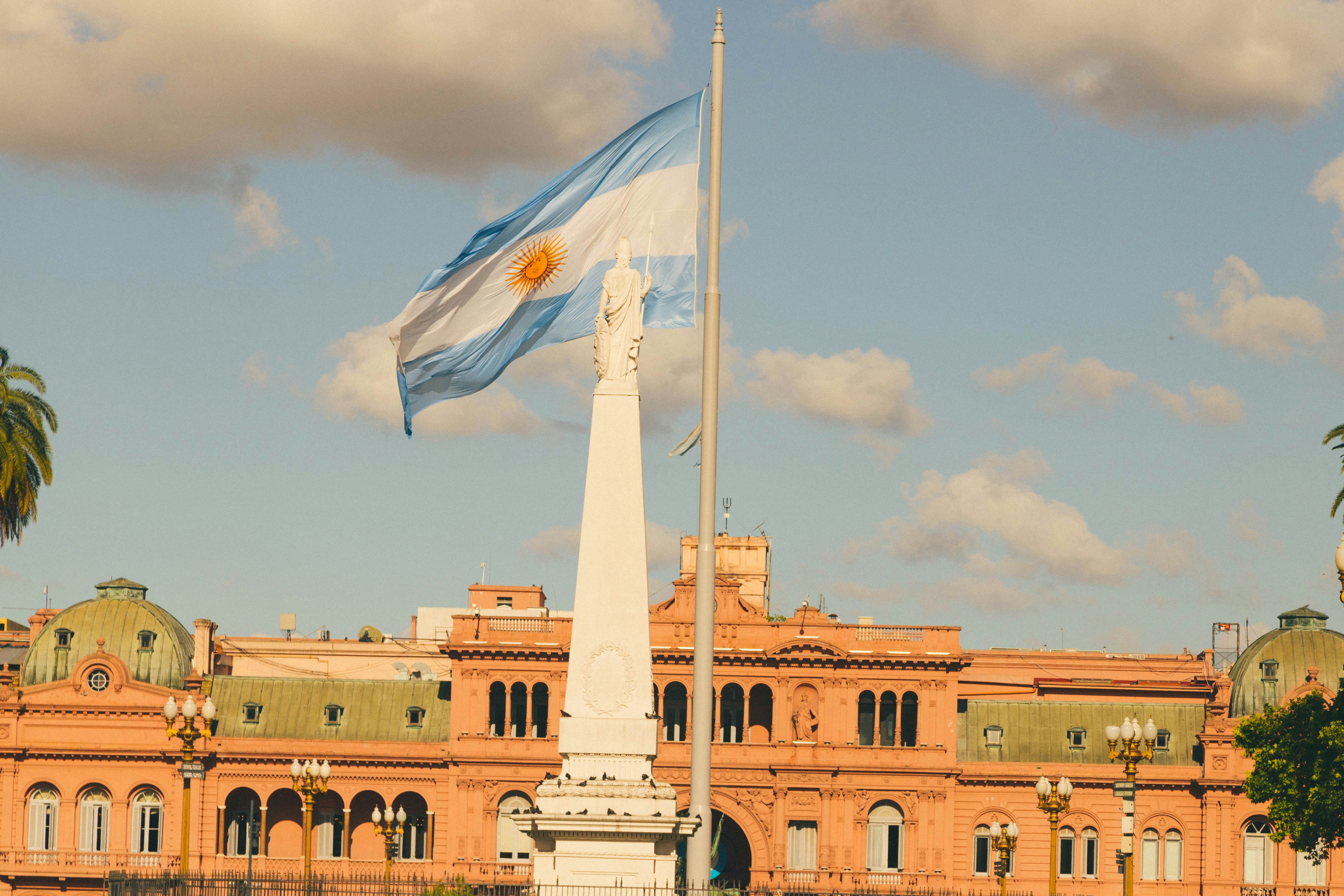 a flag flying in front of a large building