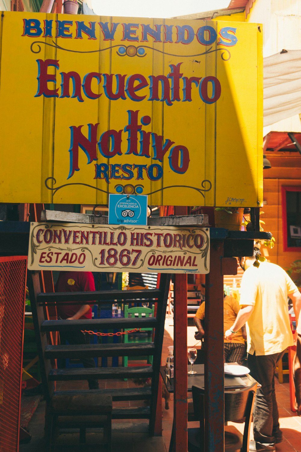 a yellow sign advertising a mexican restaurant