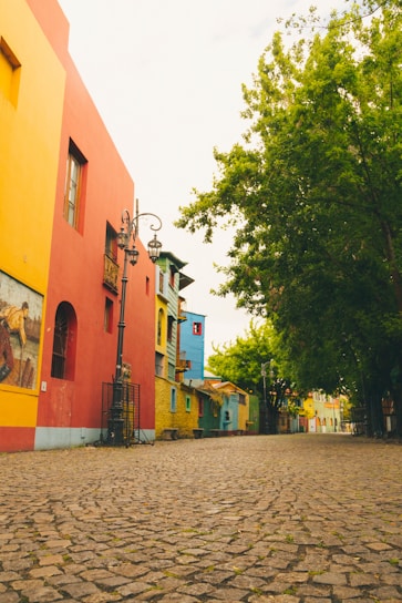 a cobblestone street lined with brightly colored buildings
