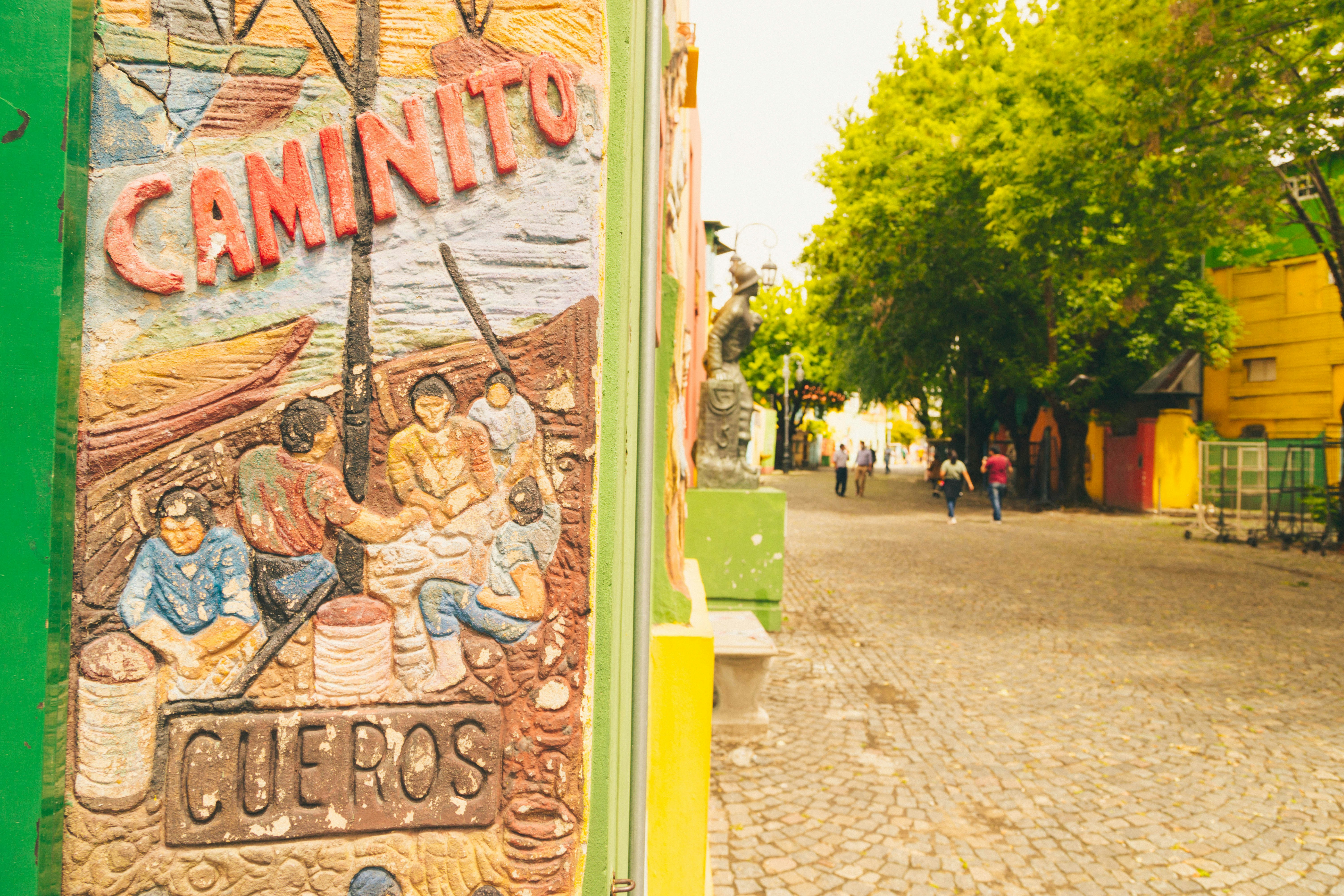 a mural on the side of a building on a cobblestone street