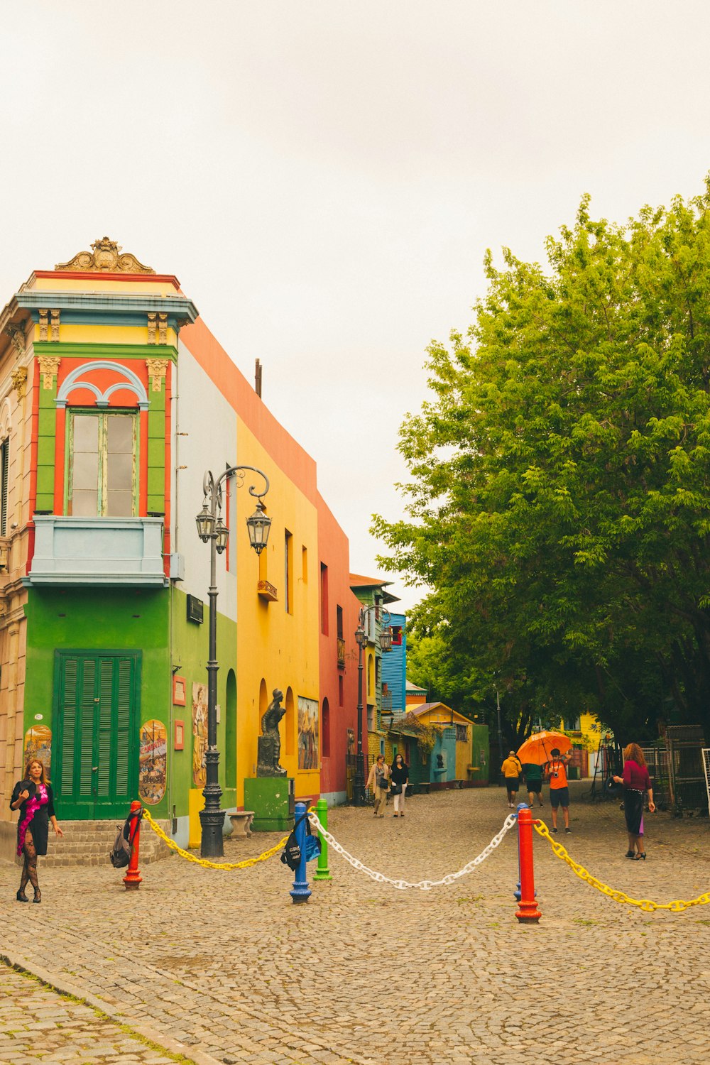 a group of people standing in front of a colorful building