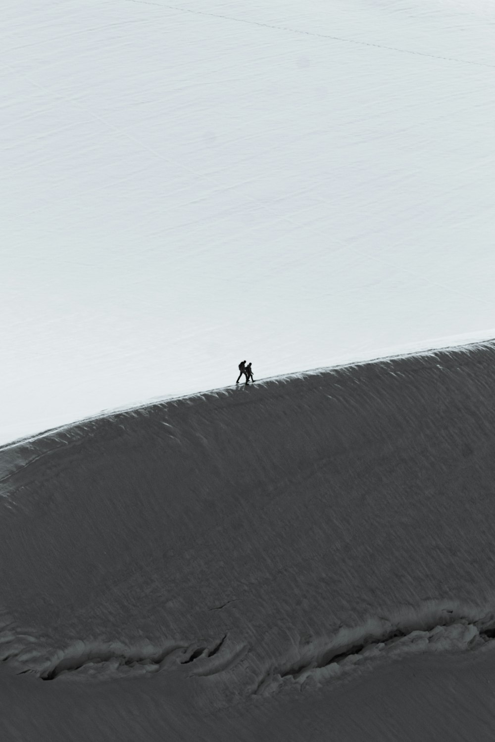 a person walking up a snow covered hill