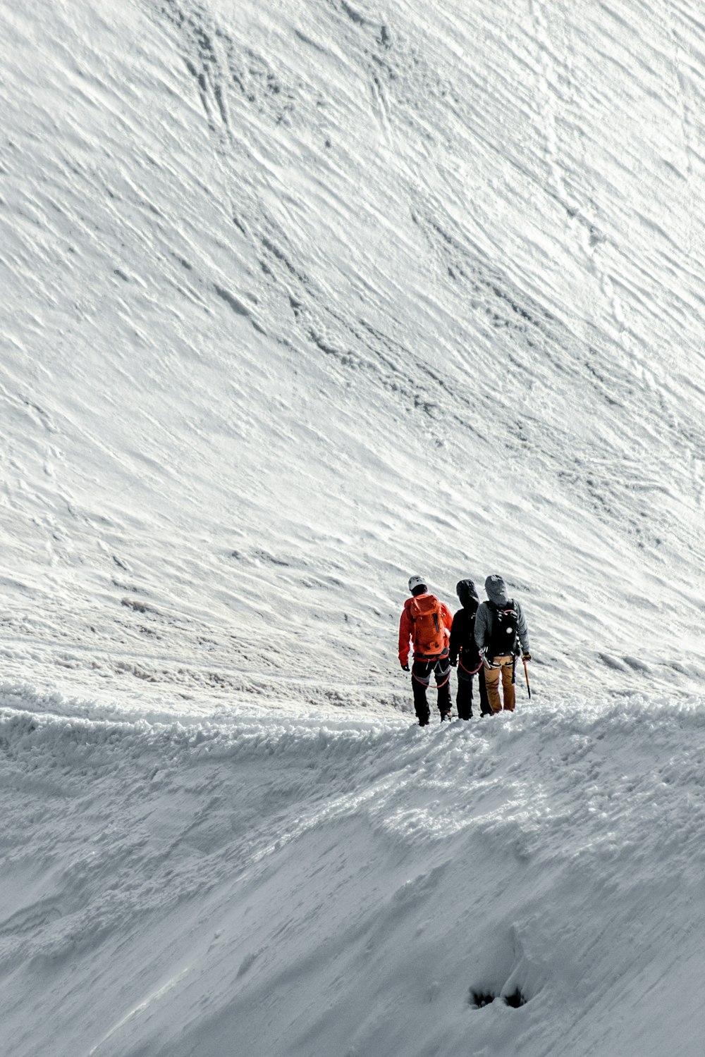 a group of people standing on top of a snow covered slope