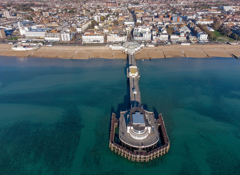 an aerial view of a pier in the middle of the ocean