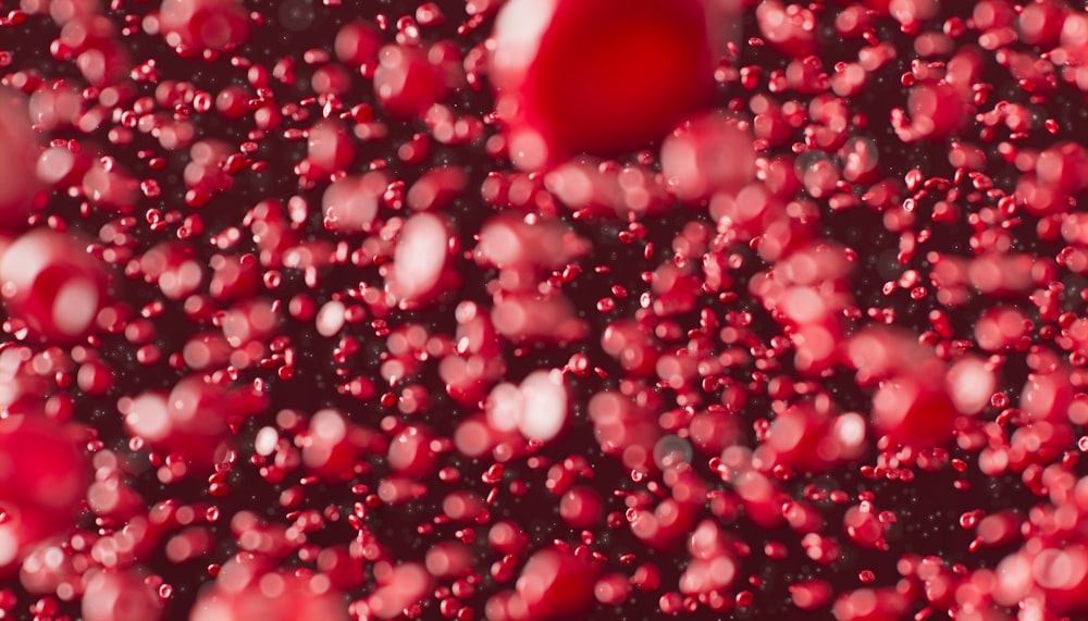 a bunch of red bubbles floating in the air