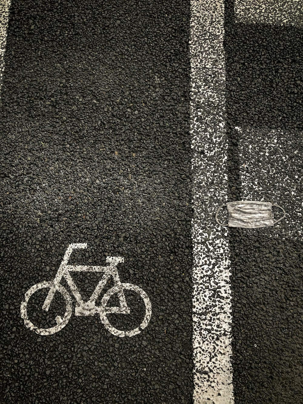 a bicycle painted on the ground in a parking lot
