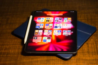 a tablet computer sitting on top of a wooden table