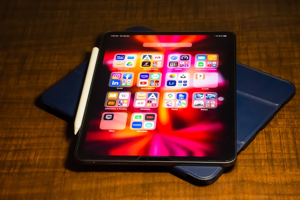 a tablet computer sitting on top of a wooden table