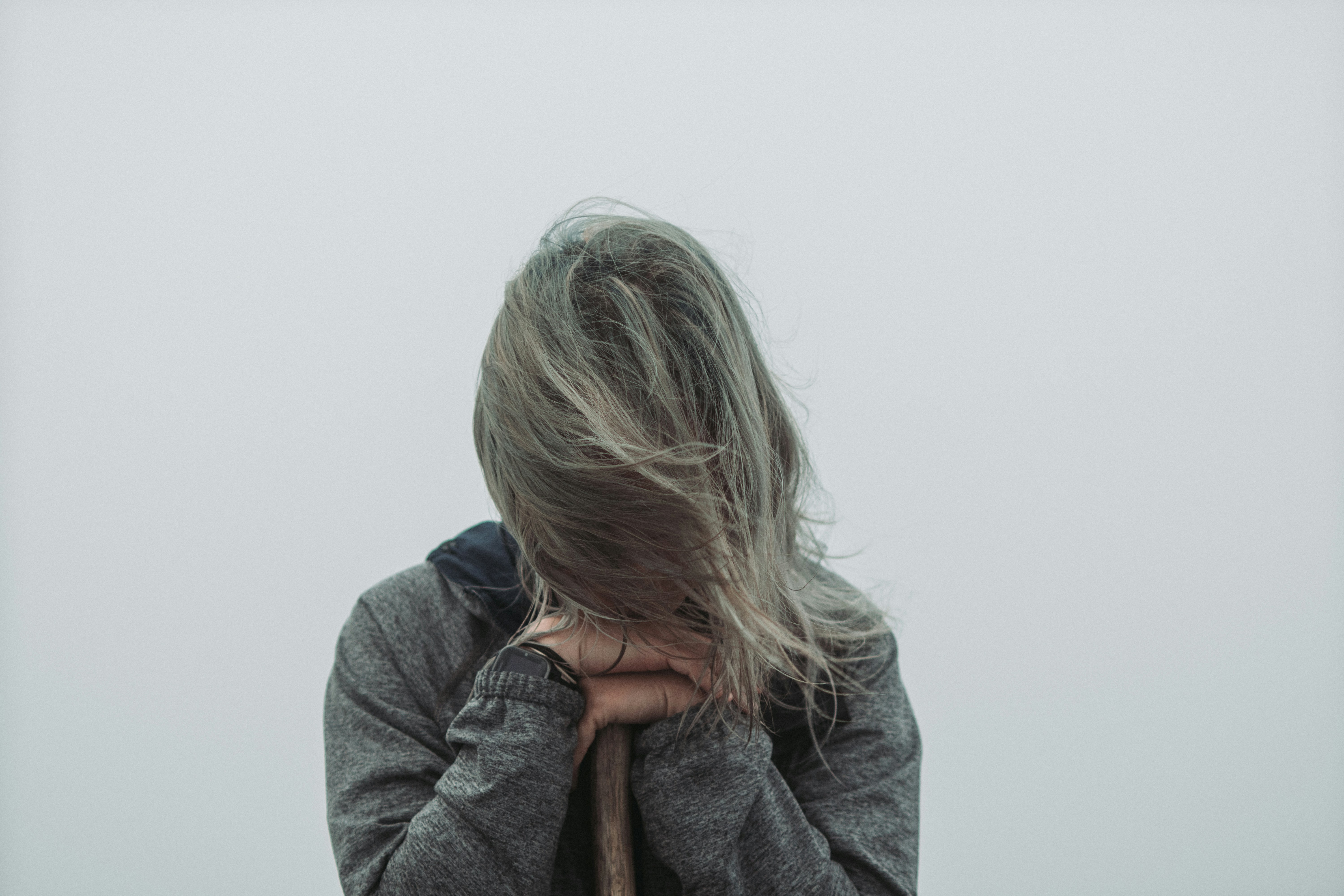 a woman with her hair blowing in the wind