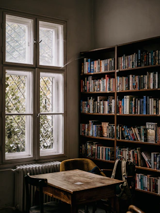 A cozy school library corner with students reading and discussing.