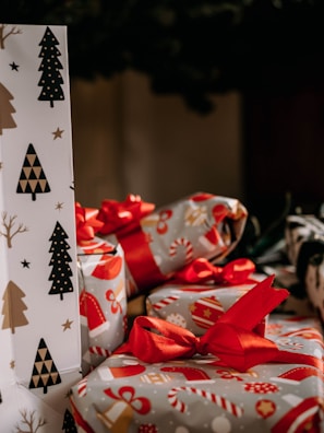 a pile of wrapped presents sitting on top of a table