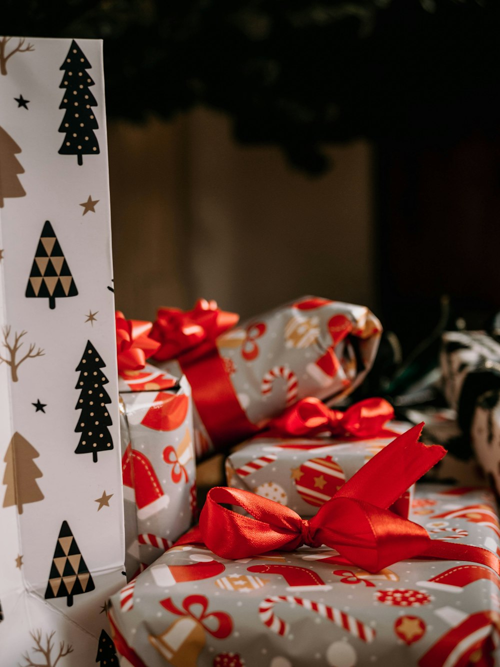 a pile of wrapped presents sitting on top of a table