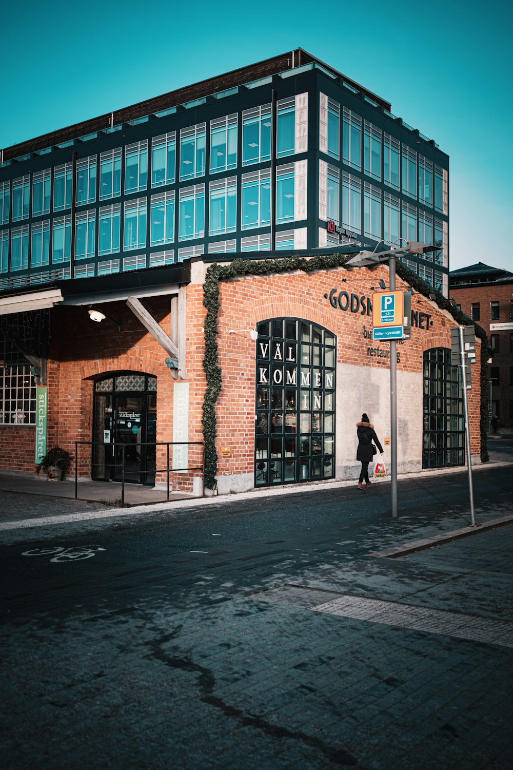 a person walking down the street in front of a building