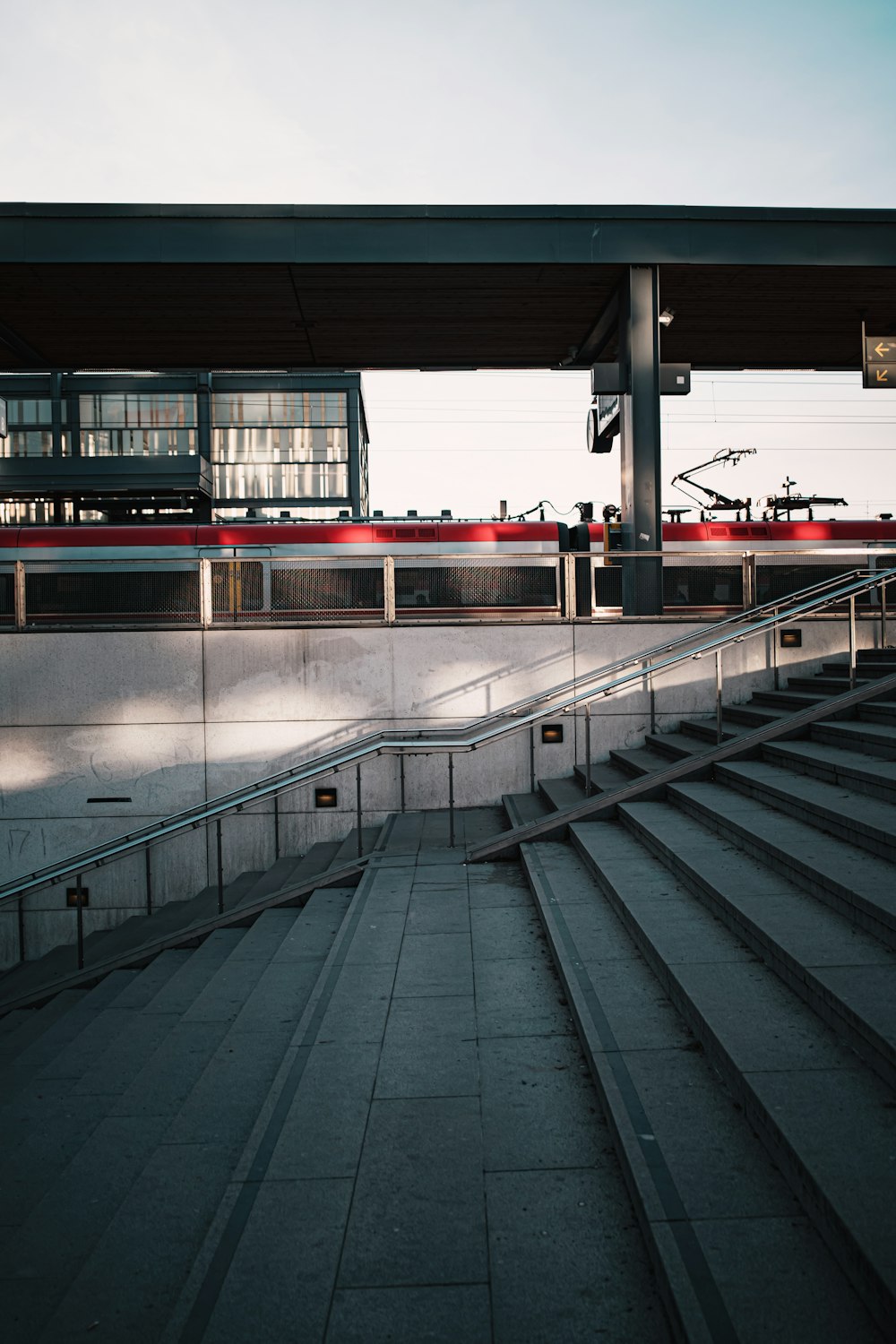 a set of stairs leading up to a train station