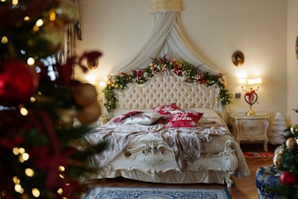 a bedroom decorated for christmas with a bed and a christmas tree