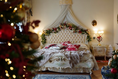 a bedroom decorated for christmas with a bed and a christmas tree