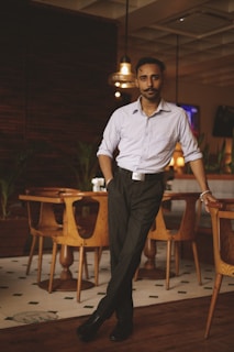 a man standing in front of a table in a restaurant