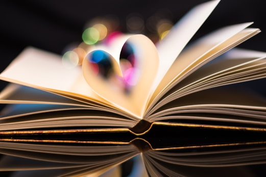 a close up of an open book with a blurry background