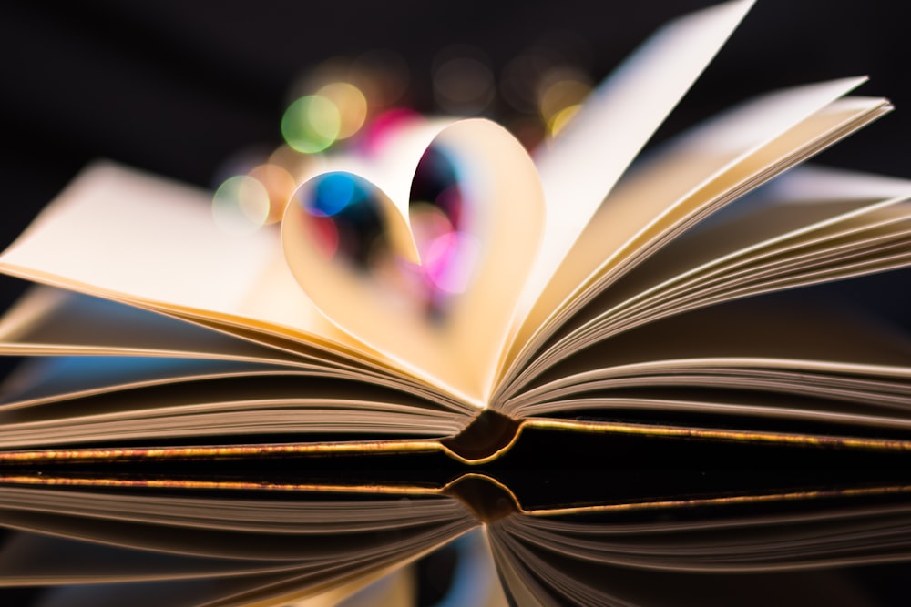 a close up of an open book with a blurry background