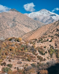 a view of a mountain range with a house in the foreground